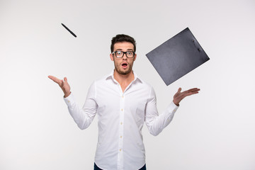Businessman throwing clipboard and pen into the air