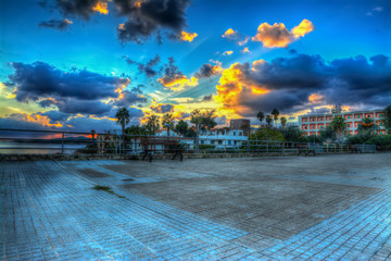 bench in a square by the sea in Fertilia