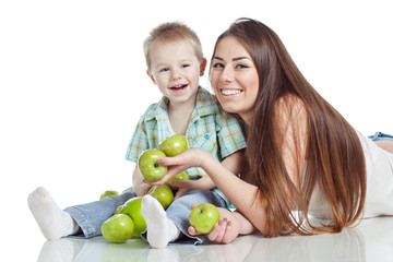 Fototapeta premium Mother with son are eating apples in studio