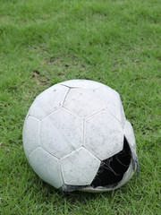 Fototapeta na wymiar worn ball on the grass