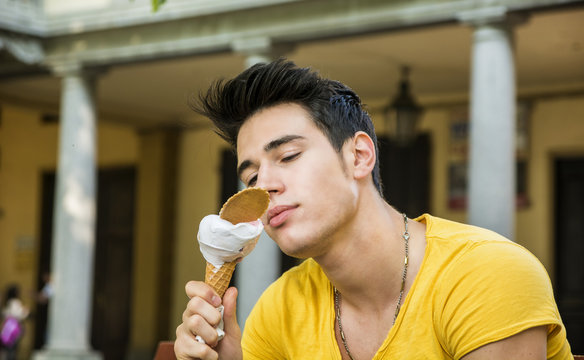 Attractive Young Man Eating Vanilla Ice Cream