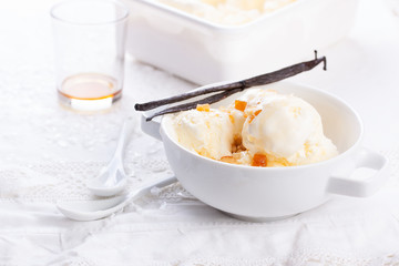 Vanilla ice cream with candied oranges on a white background for Christmas.