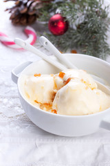 Vanilla ice cream with candied oranges on a white background for christmas