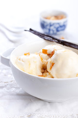 Vanilla ice cream with candied oranges on a white background