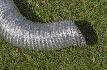 The aluminum ventilation pipe on green grass for temporary use i