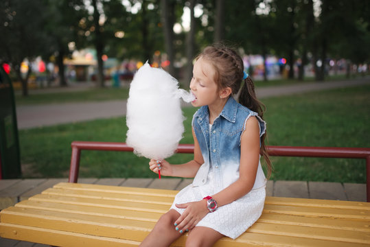 cute little girl with cotton candy in park