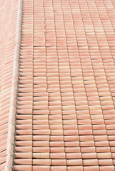 Detail of a roof with red shingles