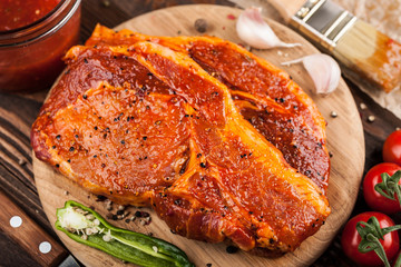 Marinated pork steaks on cutting board