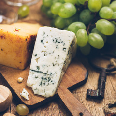Blue cheese on wooden background 