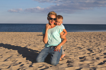 Happy family resting at beach in summer