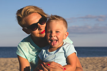 Happy family resting at beach in summer