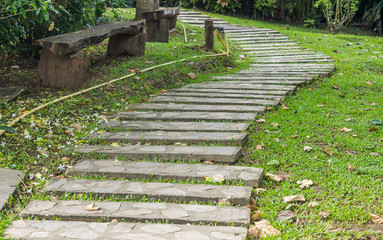 Many Stone pathway into garden in the bright day.