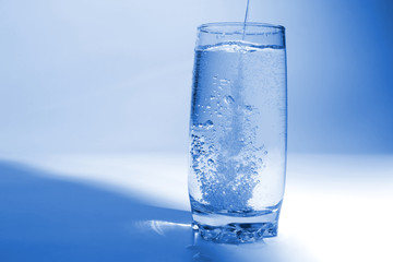 water pouring in transparent glass with bubbles of air