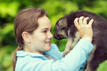 baby on hands holding a small dog