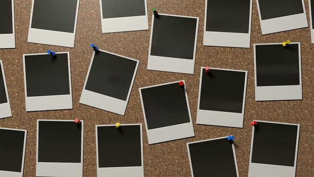 A zoom out reveal of a front view  of a collection of many blank polaroid films pinned to a cork bulletin board with various colored pushpins