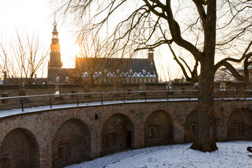 Sunset view on the city hall seen from within the walls of an ancient fortiforcation (Burcht) in Leiden, Netherlands