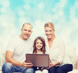 smiling family with laptop