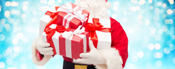 close up of santa claus with gift boxes