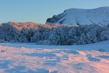 Sunset colors at mountain plateau in winter. The Chatyr-Dag mountain in Crimea at evening time.