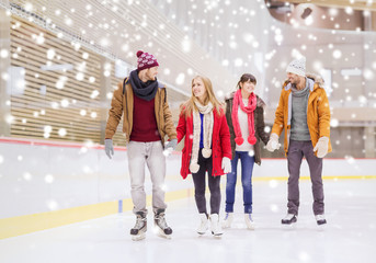 happy friends on skating rink