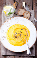 Pumpkin soup with cream, seeds and thyme 