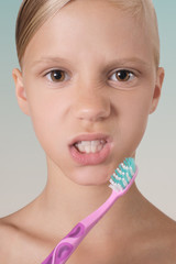 Portrait of a young girl with a toothbrush