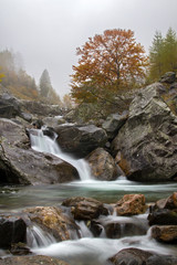 Small waterfall in a wild valley in autumn – fall