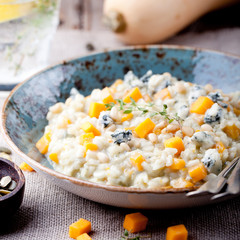 Pumpkin, blue cheese risotto in a ceramic plate 