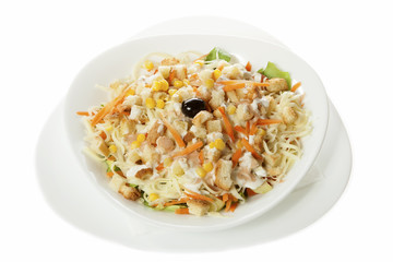Delicious salad of fresh vegetables with ham, cheese and egg, served in a white bowl. Isolated on white.