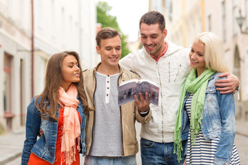 group of friends with city guide exploring town