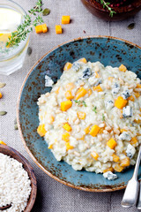 Pumpkin, blue cheese risotto in a ceramic plate 