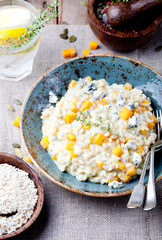 Pumpkin, blue cheese risotto in a ceramic plate 