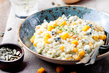 Pumpkin, blue cheese risotto in a ceramic plate 