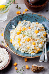 Pumpkin, blue cheese risotto in a ceramic plate 