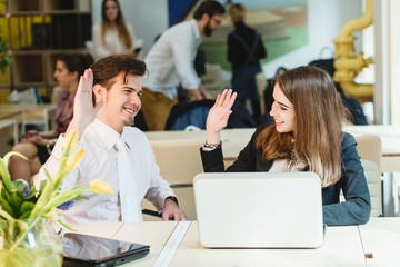 happy young relaxed couple working on laptop computer