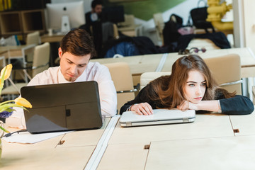 happy young relaxed couple working on laptop computer