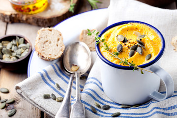 Roasted pumpkin and carrot soup with cream . 