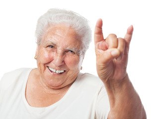 portrait of elder woman doing a rock gesture