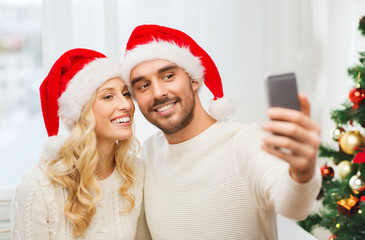 couple taking selfie with smartphone at christmas