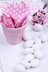 sugar coated almond candy, paper heart and flower