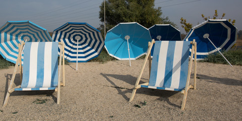 Beach scene. Colorful umbrellas lounge chairs