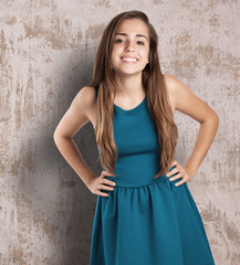 young pretty woman wearing a blue dress smiling