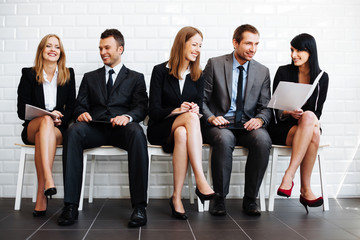 Group of happy business people sitting in waiting room