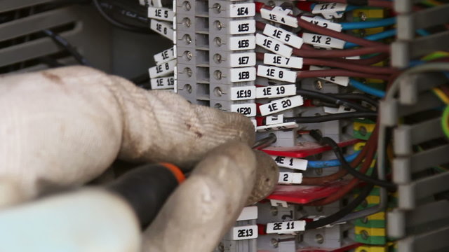 Electrician repairing a fuse box
