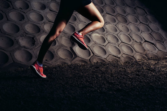 Hard Running Workout. Close-up Of Young Female Runner Legs.