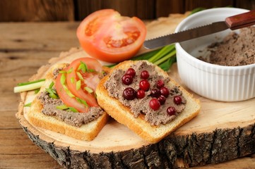 Homemade liver pate on toasts with fresh tomatoes, scallion and