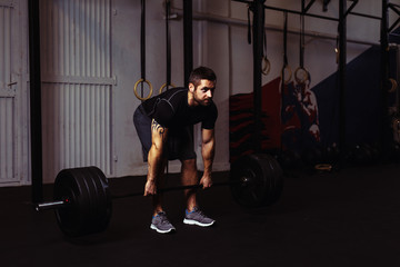Young man during deadlift exercise