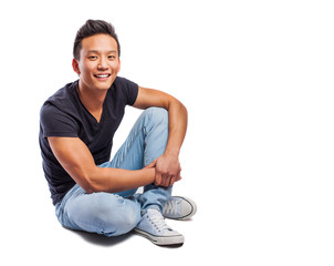 portrait of a young asian man sitting on the floor