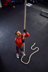 Athlete before rope climb exercise at gym
