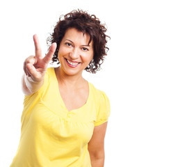 portrait of a mature woman doing the victory gesture on a white background